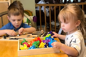 Childcare News - Boy & Girl Playing at Table